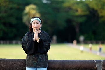 Fototapeta premium Portrait of woman wearing the traditional Khmer Krama on her head. Siem Reap. Cambodia.