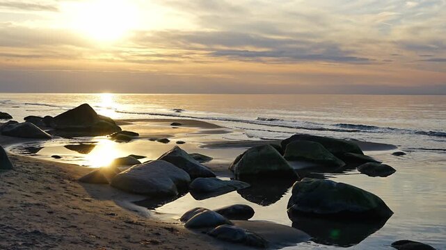 Rocky beach coastline on Ruegen island in Germany during sunset over the Baltic Sea. Travel, nature and seaside landscape with calm evening atmosphere