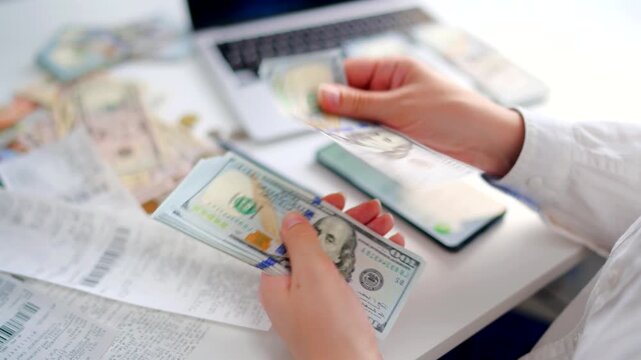Woman calculating monthly home expenses, taxes and bank account balance.