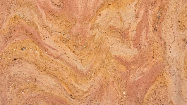 Abstract natural red clay soil texture with swirling patterns
