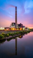 Obraz premium Industrial landscape with factory smokestack.