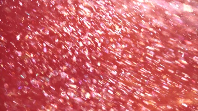 Abstract flowing champagne glitter particles with shimmering liquid texture and elegant sparkling motion. Luxurious golden glitter background with soft organic movement and cinematic aesthetic. Ideal 