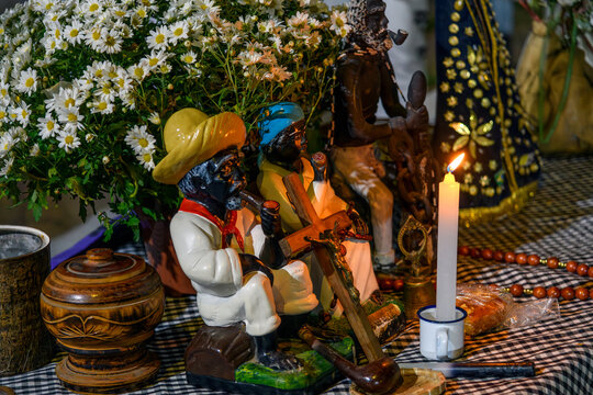 Altar with candles and flowers in homage to the Old Black Man inside an Umbanda temple.