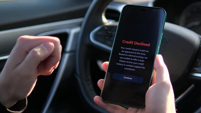 Close-up of a mobile banking app showing a loan rejection message. High-quality fintech UI for financial security, banking apps, and economic news. Perfect for ads highlighting credit challenges and