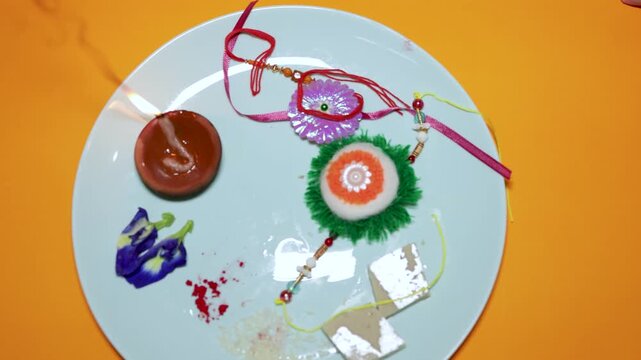 raksha bandhan festival plate with colorful rakhi and traditional diya lamp