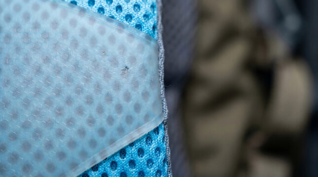 Translucent Polyurethane Abrasion Patch Fused Over Ice‑Blue Mesh &ndash; Durability Layer &ndash; Armored Breathability &ndash; Industrial Overhead LED