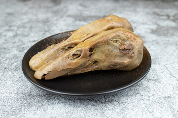 Obraz premium The spicy and savory duck head in the plate
