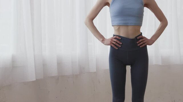 Close-up of Waist of Woman in Yoga Wear