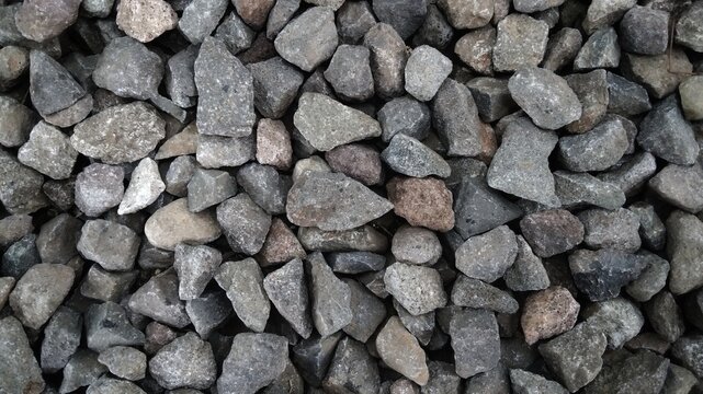​Top view of gray crushed stones background. Abstract gravel texture