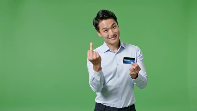 Asian man holding credit card and gesturing come here on green screen businessman