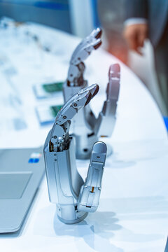 Artificial robotic hand at the presentation of robotics background.Creation of artificial intelligence