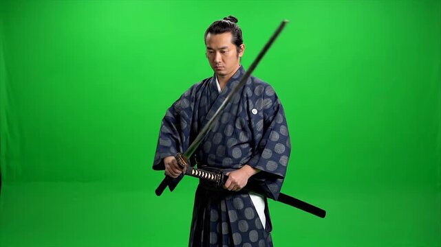 Japanese Samurai Warrior Standing with Katana Sword in Traditional Attire Against Green Screen