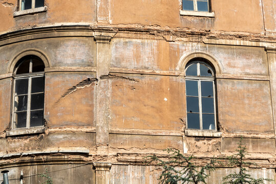 Old building shows signs of damage and wear in urban area during daylight hours