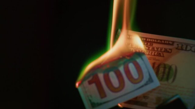 Fire money. Burning 100 bill. Hundred bucks goes up in flames. Collapse of dollar and democracy. End of capitalism, Economic crisis. Burn usd crash. Ignite American paper currency, banknotes.
