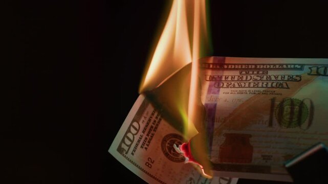 Fire money. Burning 100 bill. Hundred bucks goes up in flames. Collapse of dollar and democracy. End of capitalism, Economic crisis. Burn usd crash. Ignite American paper currency, banknotes.