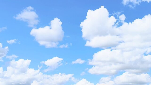Minimalist single white cloud on clear blue sky background with large copy space for text concepts of freedom peace of mind and serenity