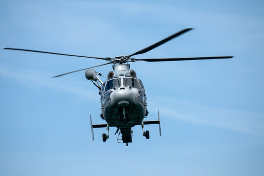 Military helicopter in flight, approaching. During a surveillance, patrol, or rescue mission. Air force