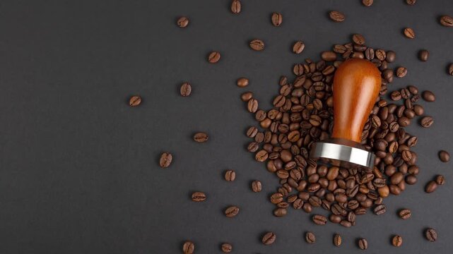 Close-up of coffee beans and tamper on a dark background, preparing for brewing