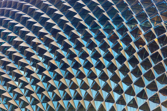 Close-up fragment of glass facade of Esplanade theater for texture background.