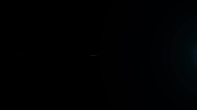 Futuristic blue optical lens flare with glowing horizontal light rays, cinematic volumetric shine, dynamic flash leak effects, abstract starburst streaks and energetic overlay on black background 4K
