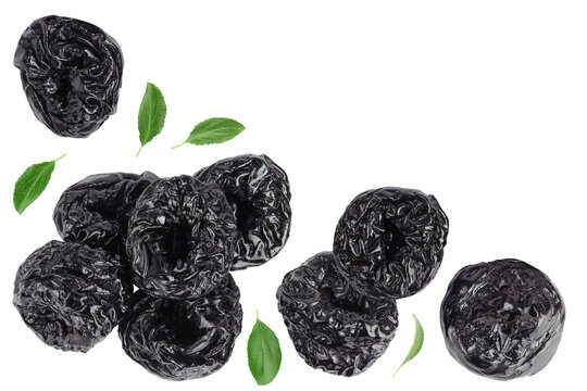 Prunes isolated on white background, heap of dried plums. Top view. Flat lay