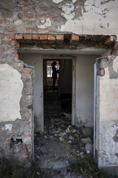 Entrance to an abandoned ruined residential building, old Soviet apartment blocks in the ghost town, Engilchek, Tian Shan, Kyrgyzstan