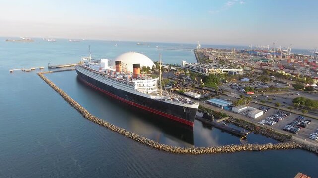 LONG BEACH, CA - August 2017: Queen Mary hotel ship docked at the Long Beach marina since 1967, slow motion aerial view