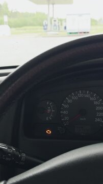 Vehicle dashboard with warning indicator. Illuminated car dashboard highlighting caution signals