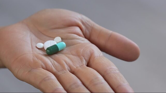 close up woman hand holding a medicine. Stop drug use Taking Medication Caring for the health care medical concept.