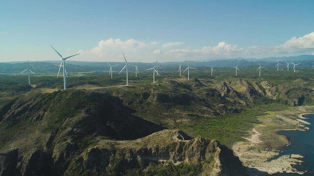 Aerial view of large wind turbines producing clean sustainable energy, clean energy future.
