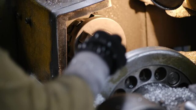 High speed rotation of metal workpiece on industrial lathe machine for precision part manufacturing in factory