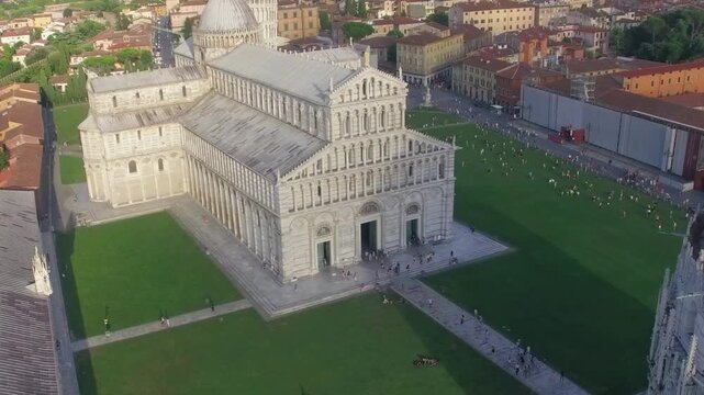 Piazza dei Miracoli aerial helicopter view capturing Leaning Tower Cathedral Baptistery and green square layout Pisa