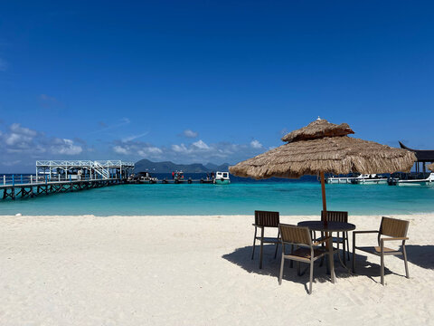 a beach scene with chairs and umbrellas