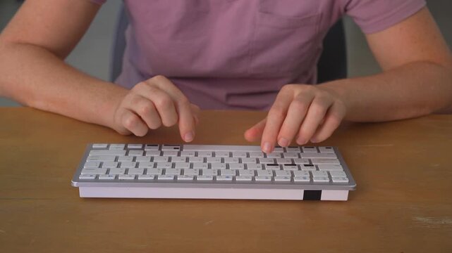 Close up woman typing on wireless keyboard on table with clear sound. Hands writing on computer device. Technology use, remote work, productivity and everyday routine concept.