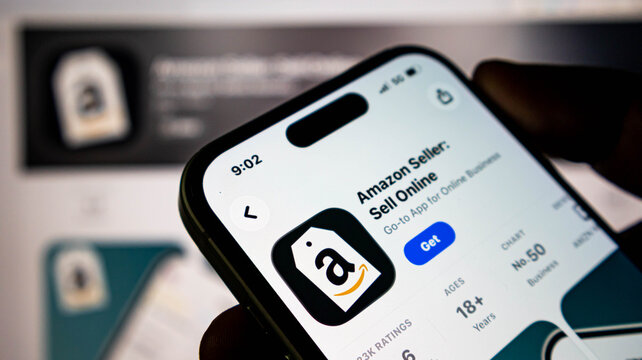 Closeup of a smartphone screen displaying the amazon seller app page in the apple app store, showing the app icon and download button