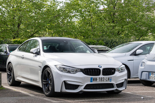 Nancy, France - April 23rd 2022 : View on a white BMW M4 F82 finished in Alpine white parked on a parking lot.