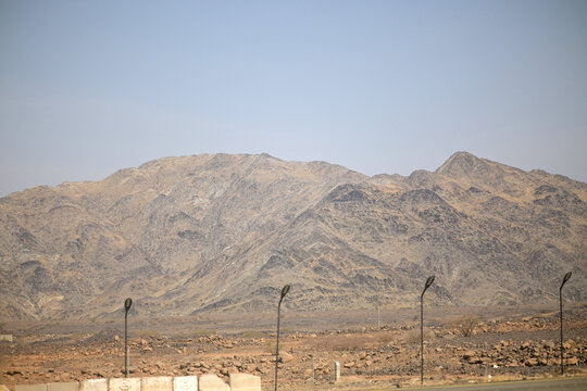 desert view with rocky mountains in the background in Mecca, Saudi Arabia