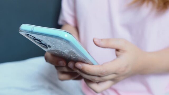 Hands holding a modern smartphone, closeup of touchscreen interaction and casual browsing to convey mobile connectivity, social media use, messaging, and everyday digital life