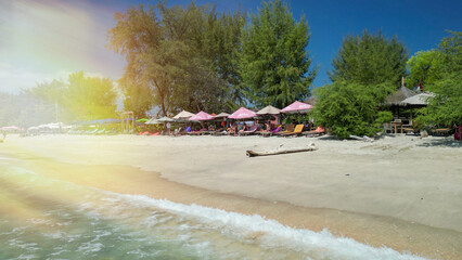 Fototapeta premium Drone view of Gili Trawangan coastline showing crystal clear ocean and tropical beaches