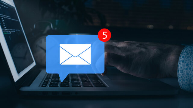 Scam message warning about phishing emails received on a laptop screen at night