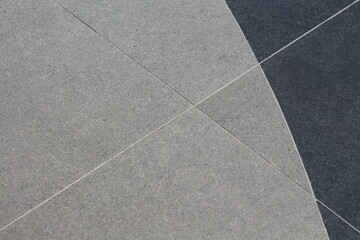 Fototapeta premium Abstract pattern of contrasting grey and dark grey textured tiles with clean grout lines
