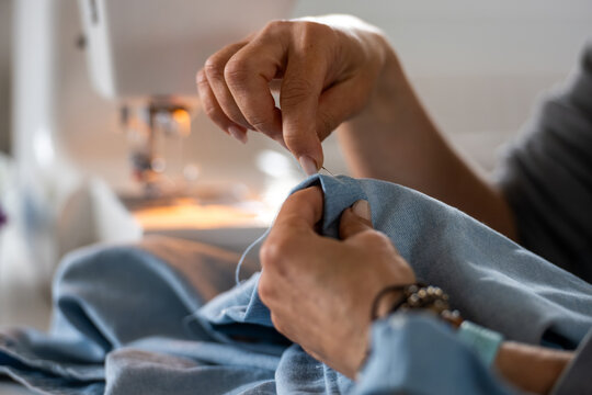 Woman Basting Fabric In Front Of Sewing Machine Construction