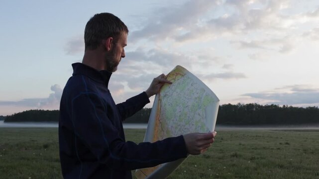 Middle age man searching in paper map and find way. Travel, adventure lifestyle concept