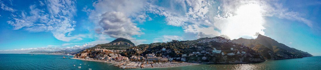 Fototapeta premium Cinematic aerial view of Marina di Vietri shoreline and Mediterranean waters in summer