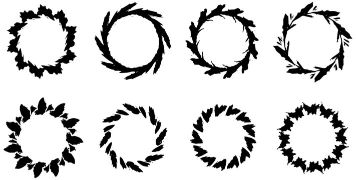 Set of eight decorative circular floral wreaths created as black silhouette vector elements for graphic design