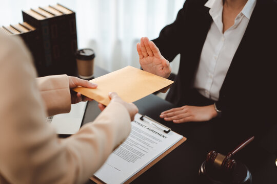 Person refusing a bribe, rejecting an envelope with illicit money, emphasizing integrity and ethical conduct in a legal or business setting, stopping corruption and dishonesty