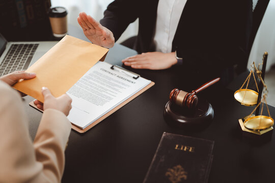 Businesswoman's hand firmly rejecting a cash bribe in a brown envelope over a contract, symbolizing integrity, anti-corruption stance and ethical refusal in a corporate legal setting