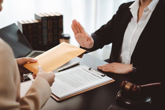 Lawyer rejecting a bribe envelope from a client, showing professional ethics and integrity, refusing corruption and illicit money in a legal setting
