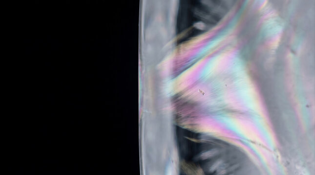 Feathery Iridescent Stress Shadow Inside Clear Ice &ndash; Pressure Shadow &ndash; Residual Force Macro &ndash; Cross‑Polarized Studio Birefringence