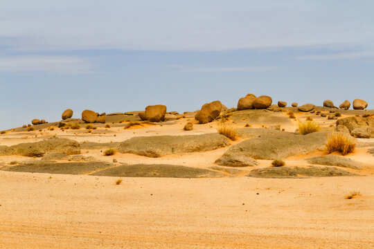 Sahara landscape. Rock formations with large, round boulders on a dune and rocks. Tassili n'Ajjer National Park, Algeria, Africa